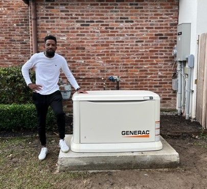Customer standing next to a Generac generator installed on a concrete pad.